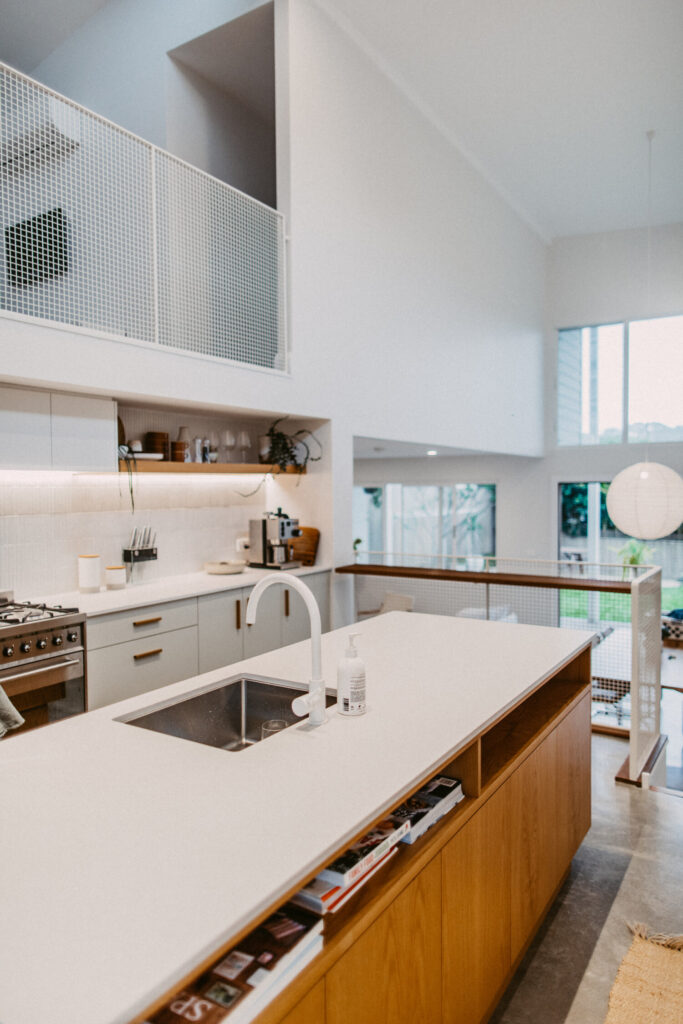 White kitchen with timber island